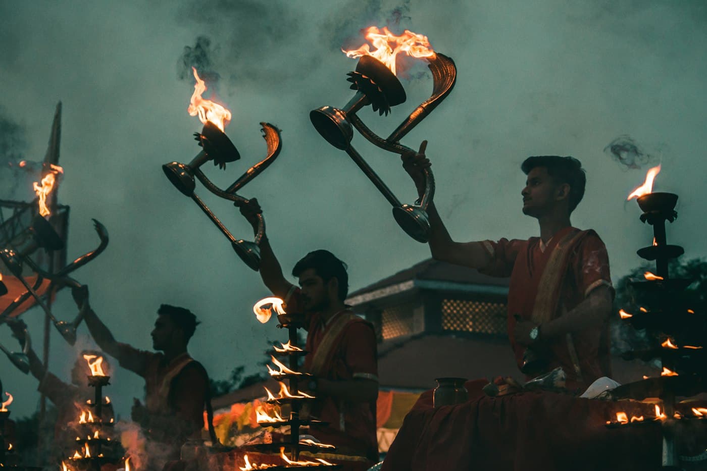 Devotee holding a flaming ritual vessel during aarti