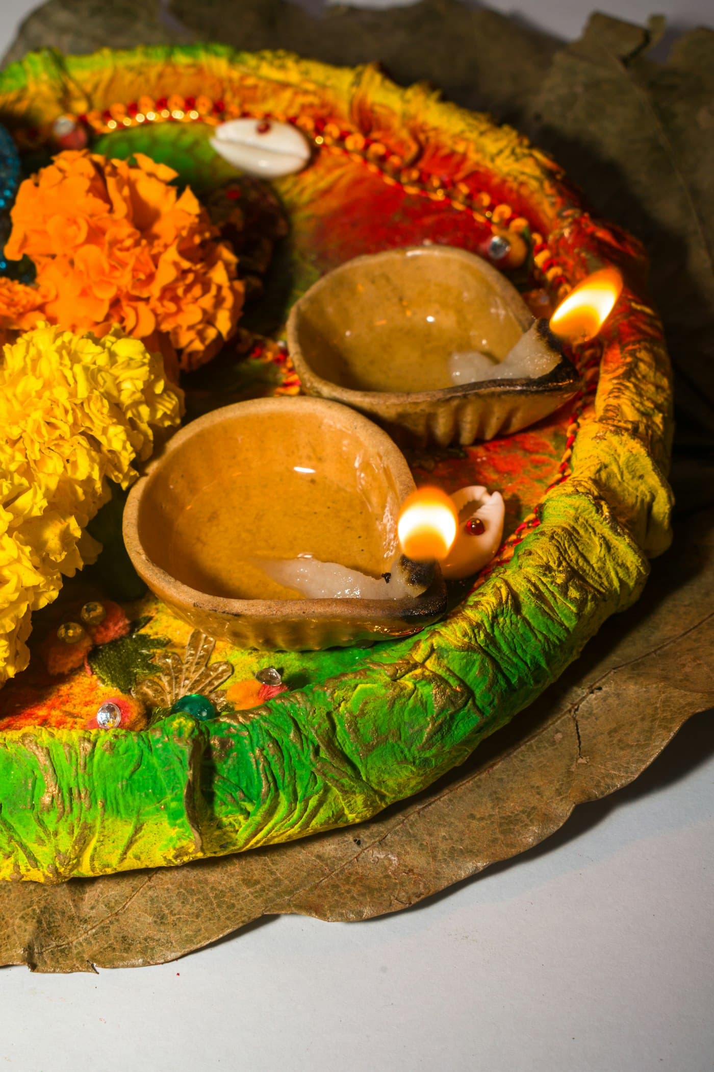 Diwali diya arrangement with warm floral accents